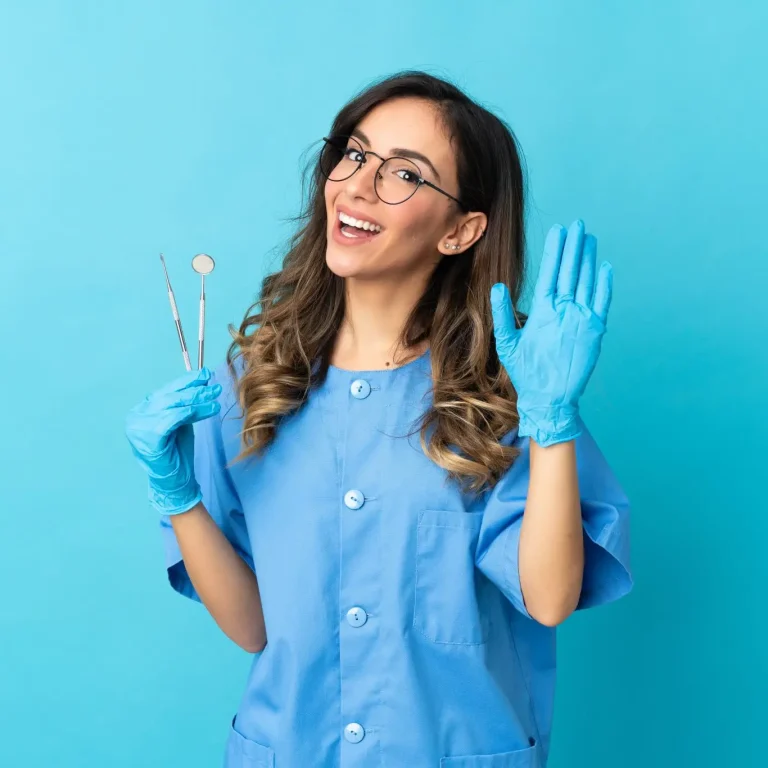 woman-dentist-holding-tools-isolated-blue-space-saluting-with-hand-with-happy-expression-2048x1366